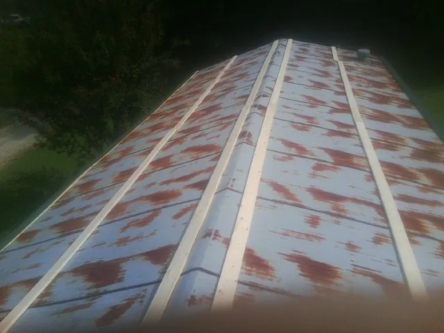 Rusted metal roof panels with new wood purlins before replacement — Storm Damage Roof Repair in Gore by Roofing Brothers