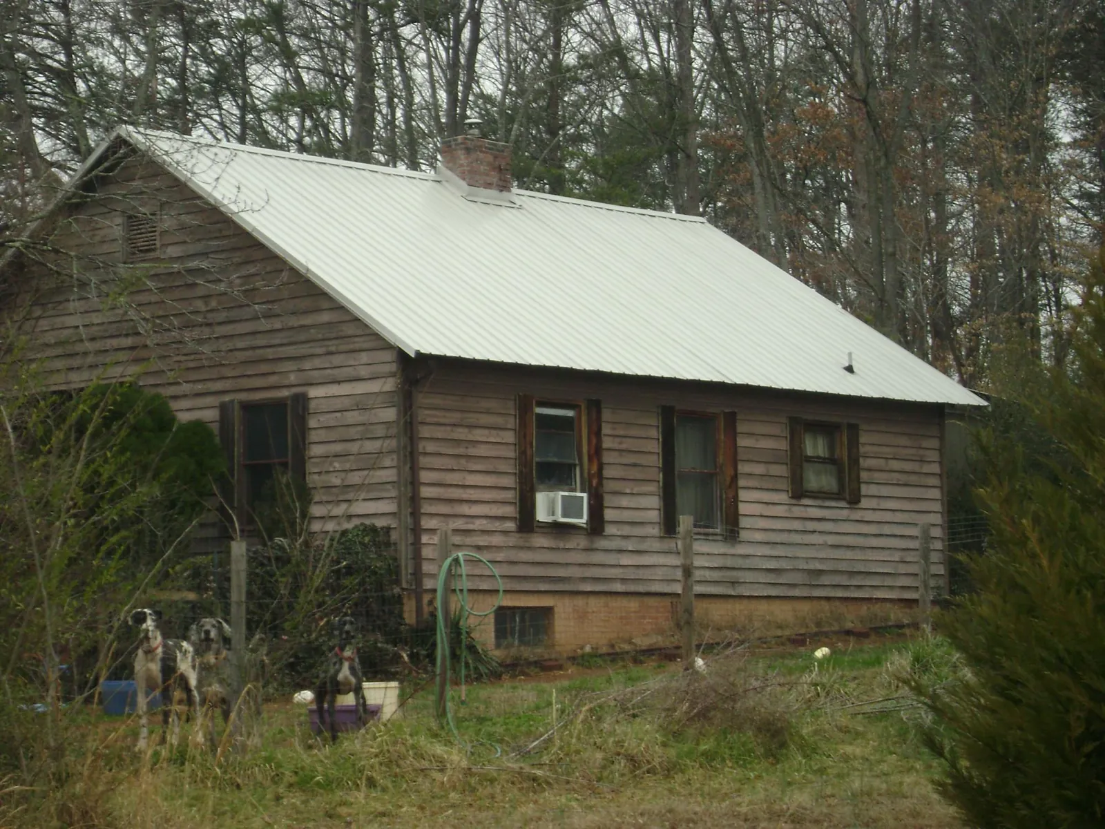 White metal roof on an old wood sided farmhouse, from a Metal Roof Installation job in Gore